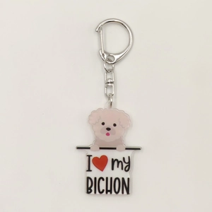 Detailed close-up of a 2D acrylic keychain featuring a pink Bichon Frise and I Love My Bichon text