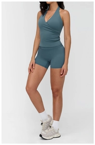 Detail of cross-back yoga top and high-waist shorts in misty blue stretch fabric