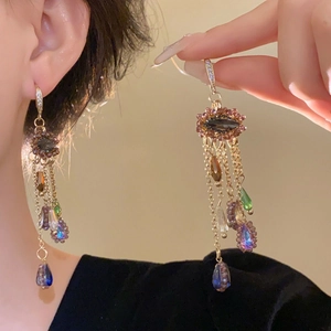 Detailed close-up of retro floral shell tassel earrings with colorful crystal accents