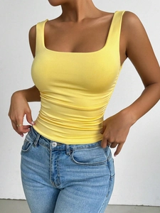 Close-up of yellow square neck tank top featuring elegant side ruched detailing on knit fabric