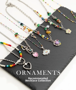 Close-up of colorful Bohemian beaded necklaces with heart and flower charms