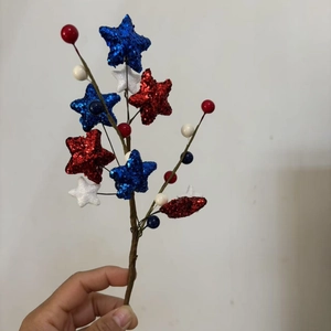 Patriotic July 4th decorative spray with red white and blue stars and glitter berries