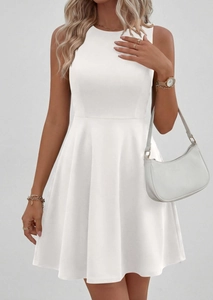 Detail view of white sleeveless dress with round neck and high-waisted A-line silhouette