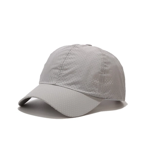 Detail of grey baseball cap featuring breathable perforated fabric for sun protection