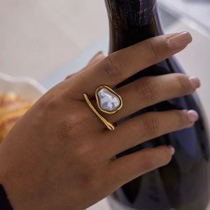 Elegant 18K gold plated stainless steel open ring with a large Baroque pearl on model