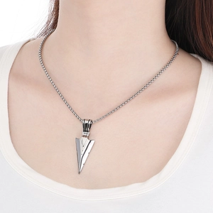 Detail shot of silver arrow pendant and metal bead chain on model in hip hop style
