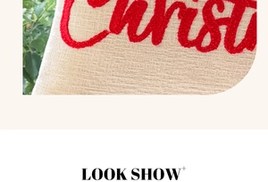 Detail of red tufted Christmas embroidery on textured cream chenille pillowcase fabric