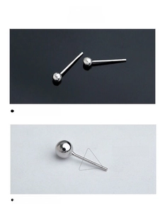 Macro detail of classic S925 sterling silver ball stud earrings on black and white background