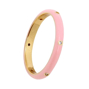 Detail of pink enamel ring with sparkling zircon stones and gold-plated metallic finish