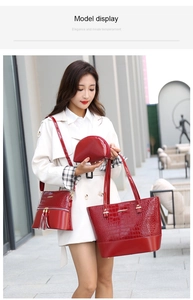 Detailed view of red crocodile pattern 3-piece bag set with tote, crossbody and clutch