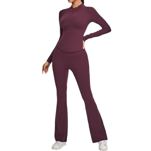 Slim fit deep purple yoga set featuring half-zip long sleeve top and flared yoga pants