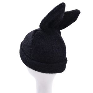 Detail showing the plush knit texture and erect rabbit ears of this warm black beanie hat