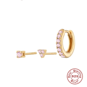 Detail of 925 sterling silver earrings with pink gems and gold plating finish
