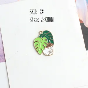 Detail of 23x30mm Monstera plant enamel charm with green leaves and white pot