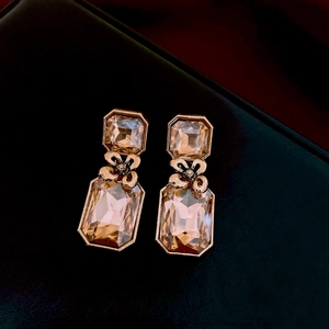 Close-up of vintage gold crystal drop earrings with champagne octagon and rectangle stones