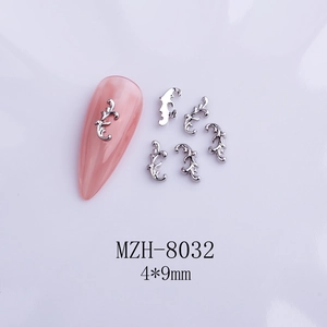 Detail view of silver bow-shaped nail charms MZH-8032 4x9mm on pink nail tip