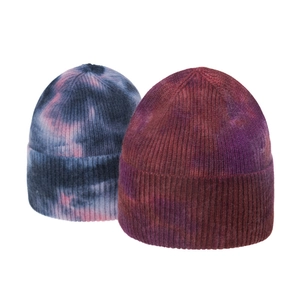 Close-up of vertical ribbed knit texture on tie-dye beanie hats in blue and purple