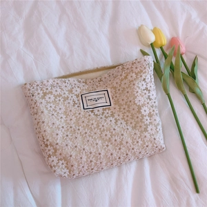 Detailed close-up of white daisy lace embroidery and Time to Party patch on small pouch