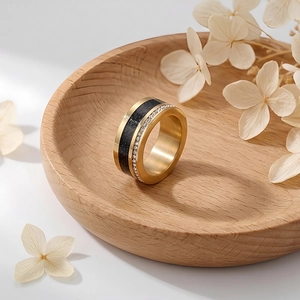 Detail of gold titanium steel ring featuring black inlay and sparkling double row crystals