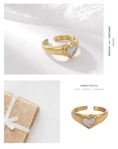 Detail of adjustable golden ring with white shell heart inlay and premium gift box