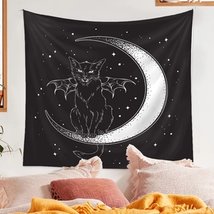 Detail of wall tapestry featuring a black cat on a crescent moon with starry night sky