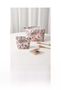 Detailed set of floral canvas makeup bags with coconut tree patterns on a white table