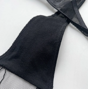 Macro shot of black mesh embroidery and cotton ribbed seams on breathable thong