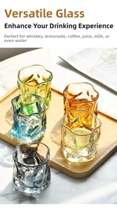 Detailed view of colorful twisted origami whiskey glasses with wave texture on wood