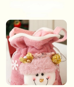 Detailed view of pink plush Christmas drawstring gift bag with sequined snowman motif
