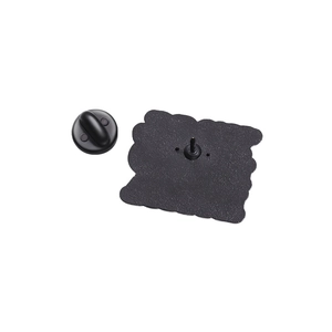 Detail of the black metal pin back showing the needle texture and rubber clutch