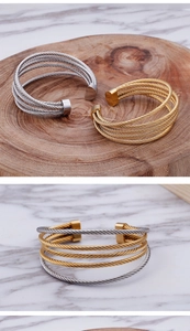 Detailed macro view of multilayered steel cable texture on gold and silver cuff bracelets