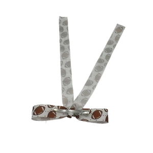 Detail view of football pattern ribbon hair bow with durable metal alligator clip