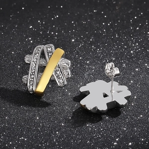 Macro shot of silver and gold hip hop earrings with pavé set sparkling crystals