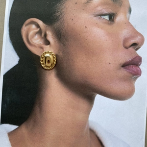 Elegant 18k gold plated stainless steel round earrings with twisted rope border on model