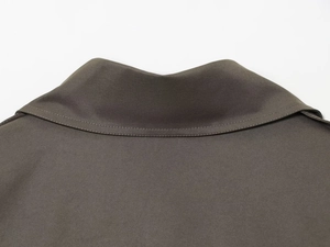 Detailed macro view of the stand collar and high-density twill fabric stitching on the coat