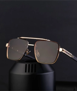 Close-up of golden metal double bridge and gradient lenses on rimless sunglasses