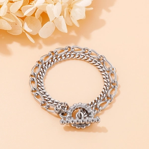 Detailed close-up of a silver double-layer titanium chain bracelet with toggle clasp