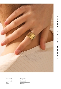 Detail of 18K gold-plated wide textured ring with hammer finish on a female hand