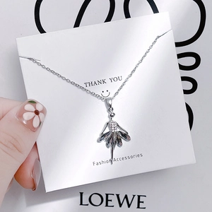 Detail view of a silver ballerina pendant necklace with crystal inlay and layered petals