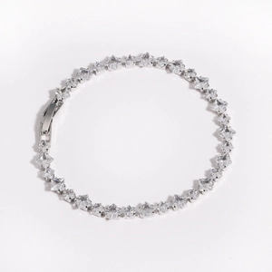 Detailed close-up of square-cut zircon tennis bracelet with silver finish and secure clasp