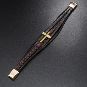 Close-up of dark brown layered leather bracelet with golden cross and magnetic clasp