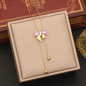 Long tassel bow necklace with pink purple gemstone in gold stainless steel finish