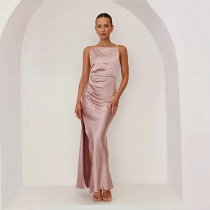 Detail view of the elegant ruched side and high slit on this champagne satin slip dress