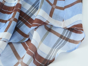 Close-up detail of blue and brown checkered ramie cotton fabric with soft texture