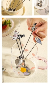 Detailed close-up of stainless steel cat coffee spoon with colorful enamel charm detailing
