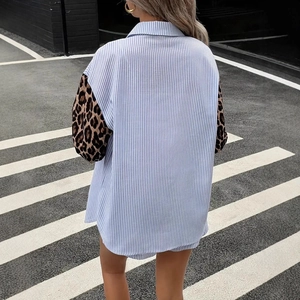 Detail of blue striped shirt with leopard print sleeves from a street style back view