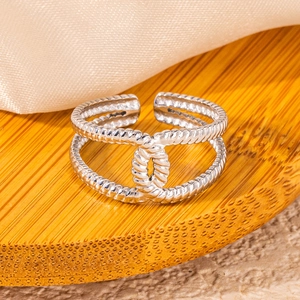 Macro view of silver double-layered rope textured ring with intertwined CC logo design