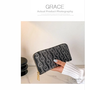 Detail of slim PU leather wallet with interlocking chain pattern and gold zipper closure
