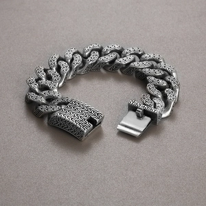 Macro shot of silver stainless steel trident bracelet with vintage labyrinth textures
