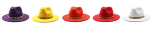 Flat lay of five colorful wool fedoras with leather bands and gold rivets on white background
